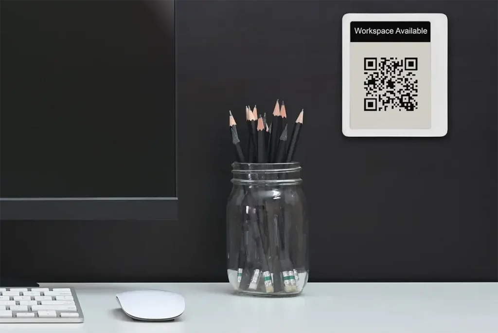 E Ink desk signs let people scan a QR code to book a space, check in for a reservation or browse out to your calendar app.