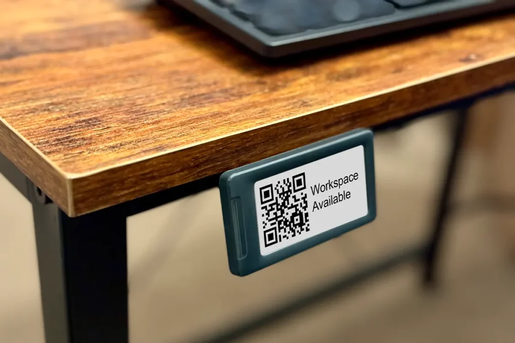 small epaper sign attached to the edge of a desk for workspace hoteling