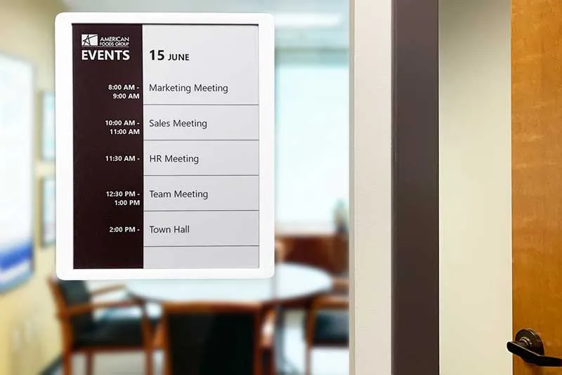 EPS 125 ePaper room sign showing meeting schedule - mounted on glass outside a conference room