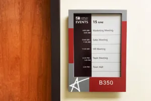 EPS 125 ePaper meeting room sign with custom branded faceplate mounted on wall