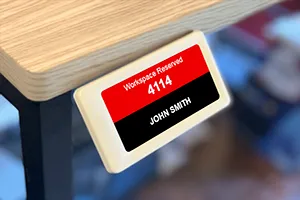 EPS 27 ePaper sign mounted on edge of desk to show workspace reservation