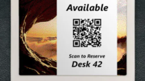 ePaper desk sign with desk reservation QR code in white block on graphic photo background