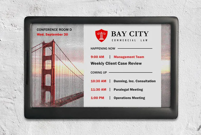 ePaper room sign with law office branding showing meeting schedule and logo on Golden Gate Bridge graphic background