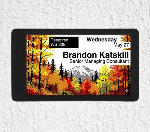 ePaper desk sign with colorful autumn tree graphic background showing desk reservation data